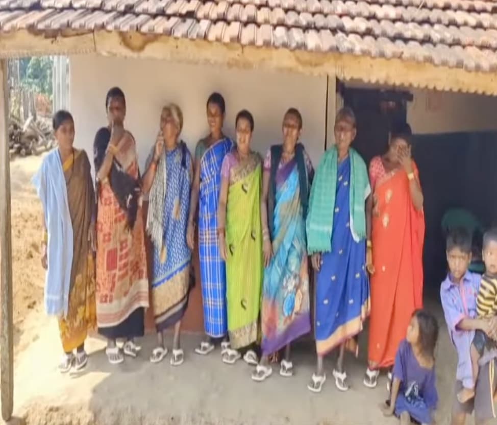 Tribal women in Pedhapadu receiving slippers from Pawan Kalyan
